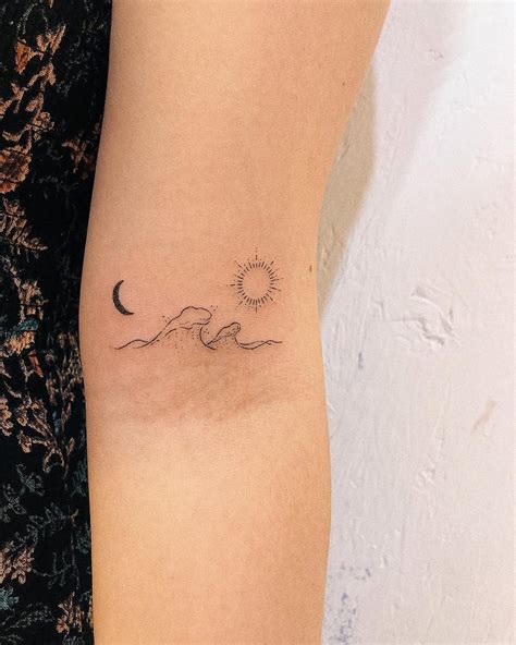 The Sun Moon And Wave Tattoo Is A Captivating Design That Blends Three Powerful Symbols From Nature The Sun Often Represents Life Energy And Strength While The Moon Symbolizes Mystery Intuition And